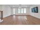 Finished basement area with hardwood floors, access to outdoors, recessed lighting and TV at 4505 Caroline Walk, Dunwoody, GA 30338