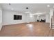 Finished basement with hardwood style flooring, large TV, and ample space for entertaining at 4505 Caroline Walk, Dunwoody, GA 30338