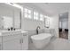 A luxurious bathroom featuring a soaking tub, double vanities, and designer tile floors at 4505 Caroline Walk, Dunwoody, GA 30338