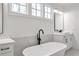 Bathroom showcasing a modern soaking tub, double sinks, and elegant finishes at 4505 Caroline Walk, Dunwoody, GA 30338