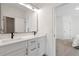 Modern bathroom features double sinks, white cabinets, and black hardware fixtures at 4505 Caroline Walk, Dunwoody, GA 30338