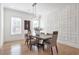 Bright dining room with hardwood floors, wainscoting, and a modern light fixture at 4505 Caroline Walk, Dunwoody, GA 30338