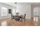 Bright dining room with hardwood floors, wainscoting, and a modern light fixture at 4505 Caroline Walk, Dunwoody, GA 30338
