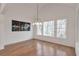 Sunlit dining room featuring a large window and modern light fixture at 4505 Caroline Walk, Dunwoody, GA 30338
