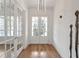 Bright foyer with hardwood floors, modern lighting, and access to other rooms in the home at 4505 Caroline Walk, Dunwoody, GA 30338