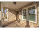 Covered front porch with brick flooring, white columns, and a view of the neighborhood at 4505 Caroline Walk, Dunwoody, GA 30338