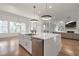 Bright kitchen with stainless steel appliances, a large island, and pendant lighting at 4505 Caroline Walk, Dunwoody, GA 30338