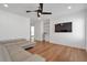 Relaxing living room includes hardwood floors, ceiling fan, and built-in shelving at 4505 Caroline Walk, Dunwoody, GA 30338