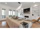 Bright living room with fireplace, built-ins, hardwood floors, and modern furnishings at 4505 Caroline Walk, Dunwoody, GA 30338