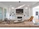 Bright living room with fireplace, built-ins, hardwood floors, and modern furnishings at 4505 Caroline Walk, Dunwoody, GA 30338