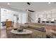 Open floor plan living room with hardwood floors, modern lighting, and breakfast bar at 4505 Caroline Walk, Dunwoody, GA 30338