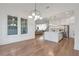 Bright room with large windows and hardwood flooring, leads into modern kitchen at 4505 Caroline Walk, Dunwoody, GA 30338