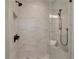 Walk-in shower with marble tile surround and bronze fixtures at 4505 Caroline Walk, Dunwoody, GA 30338