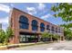 Beautiful brick building with arched windows, street view and professional landscaping on a sunny day at 112 Rogers St # 208, Atlanta, GA 30317