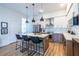 Stylish kitchen with island seating, stainless steel appliances, and modern pendant lighting at 112 Rogers St # 208, Atlanta, GA 30317