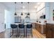Modern kitchen featuring an island, stainless steel appliances, and unique pendant lighting at 112 Rogers St # 208, Atlanta, GA 30317