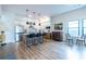 Modern kitchen with stainless steel appliances, island with seating, and hardwood floors at 112 Rogers St # 208, Atlanta, GA 30317