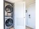 Efficient laundry area showcasing a stacked washer and dryer, maximizing space in this modern home at 112 Rogers St # 208, Atlanta, GA 30317