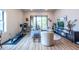 Bright living room with a balcony, a work station, hardwood floors and modern decor at 112 Rogers St # 208, Atlanta, GA 30317