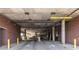 Parking garage with brick walls, concrete pillars, and overhead clearance signage at 112 Rogers St # 208, Atlanta, GA 30317
