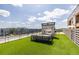 Enjoy outdoor living with this rooftop deck featuring a cozy fireplace, turf, and stylish seating area at 112 Rogers St # 208, Atlanta, GA 30317