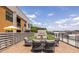 Relax on this rooftop deck with comfortable seating around a central fireplace, perfect for entertaining at 112 Rogers St # 208, Atlanta, GA 30317