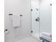 Elegant walk-in shower with glass door, sleek fixtures, and stacked towels at 112 Rogers St # 208, Atlanta, GA 30317