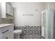 Updated bathroom featuring a black and white tiled floor, white vanity, and a glass-enclosed shower at 1350 Overlook Se Cv, Smyrna, GA 30080