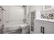 Well-lit bathroom featuring a tub, shower, and vanity with modern fixtures and stylish tile accents at 1350 Overlook Se Cv, Smyrna, GA 30080