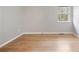 An additional view of this home's bedroom shows its hardwood floors and the window with outdoor views at 1350 Overlook Se Cv, Smyrna, GA 30080