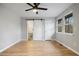 Bedroom with hardwood floors, a ceiling fan, and a barn door leading to the bathroom at 1350 Overlook Se Cv, Smyrna, GA 30080