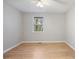 Bright bedroom features a ceiling fan, hardwood floors, neutral paint, and a window with a view at 1350 Overlook Se Cv, Smyrna, GA 30080