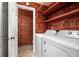 Laundry room featuring a washer, a dryer, shelves, and patterned wallpaper at 1350 Overlook Se Cv, Smyrna, GA 30080
