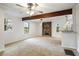Open floor plan with a living area, a stone fireplace, carpet floors, and a ceiling fan at 1350 Overlook Se Cv, Smyrna, GA 30080