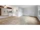 Spacious living room with tan carpet and a ceiling fan, adjoined to the dining and kitchen areas at 1350 Overlook Se Cv, Smyrna, GA 30080