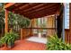 Cozy porch with an outdoor rug, fern plants, and seating under a pergola with string lights at 1350 Overlook Se Cv, Smyrna, GA 30080