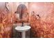 Unique powder room with floral wallpaper, a pedestal sink, and decorative fixtures at 1350 Overlook Se Cv, Smyrna, GA 30080