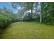 Large backyard featuring mature trees and green space, ideal for outdoor activities at 4457 Huntshire Dr, Stone Mountain, GA 30083