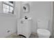 Bathroom with bright white vanity and mirror paired with tile flooring at 4457 Huntshire Dr, Stone Mountain, GA 30083