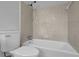 Bathroom featuring a white toilet and tub with shower at 4457 Huntshire Dr, Stone Mountain, GA 30083