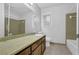 Bathroom with vintage vanity, mirror, green tile, and linoleum flooring at 4457 Huntshire Dr, Stone Mountain, GA 30083