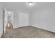 Bedroom featuring neutral carpet, a closet, and a door to the hallway at 4457 Huntshire Dr, Stone Mountain, GA 30083