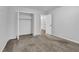 Bedroom showcasing neutral carpet, a closet, and a door to the hallway at 4457 Huntshire Dr, Stone Mountain, GA 30083