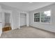 Bedroom showcasing neutral carpet, a closet, and a large window for natural light at 4457 Huntshire Dr, Stone Mountain, GA 30083