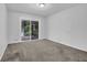 Bedroom featuring neutral carpet and sliding door access to the screened in deck at 4457 Huntshire Dr, Stone Mountain, GA 30083