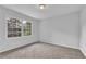 Bright bedroom featuring neutral carpet, walls, and a window overlooking the outdoors at 4457 Huntshire Dr, Stone Mountain, GA 30083