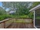 Wooden deck overlooking the lush backyard is great for outdoor relaxation and entertainment at 4457 Huntshire Dr, Stone Mountain, GA 30083