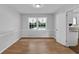 Well-lit dining room with wood-look flooring and classic window trim at 4457 Huntshire Dr, Stone Mountain, GA 30083