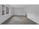 Bright, carpeted room with large windows and neutral walls, perfect for customization at 4457 Huntshire Dr, Stone Mountain, GA 30083