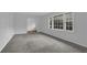 Carpeted, light-filled room with large windows, ideal for living or bedroom space at 4457 Huntshire Dr, Stone Mountain, GA 30083